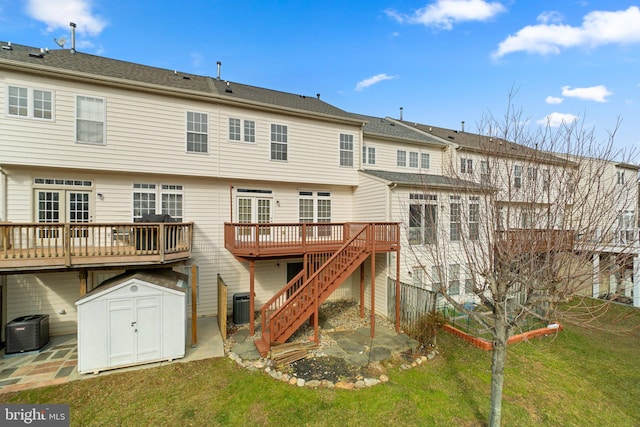 rear view of property with central AC unit, an outbuilding, stairs, a deck, and a shed