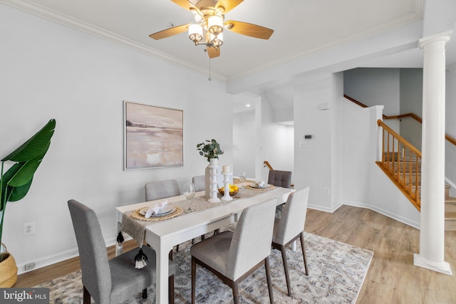 dining room with light wood-style floors, stairs, and ornamental molding