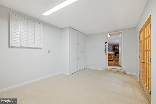 carpeted empty room featuring a fireplace