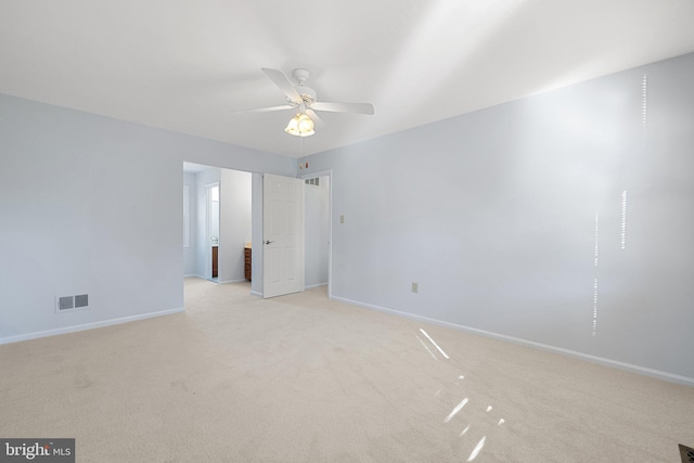 spare room featuring ceiling fan and light carpet