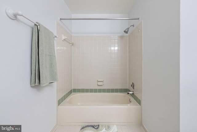 bathroom featuring tiled shower / bath combo and tile patterned floors