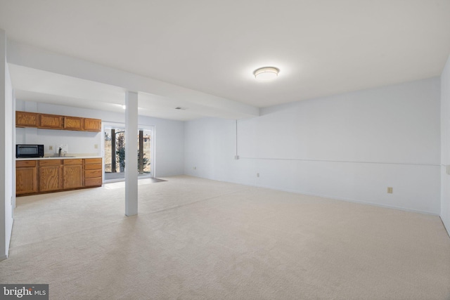 basement with light carpet and sink