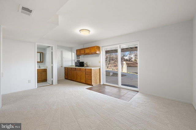 kitchen with light colored carpet