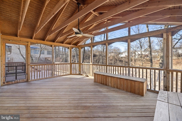 unfurnished sunroom with vaulted ceiling with beams, ceiling fan, and wood ceiling