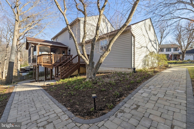 view of property exterior featuring a wooden deck