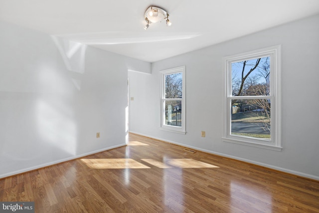 spare room with hardwood / wood-style floors