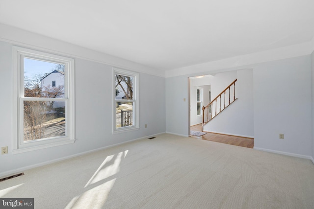 unfurnished living room with light carpet