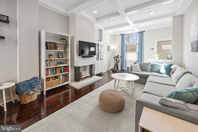 living room with coffered ceiling, a fireplace with raised hearth, wood finished floors, beamed ceiling, and recessed lighting