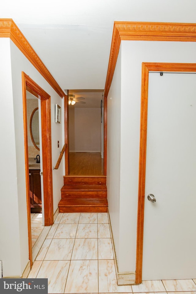 corridor with stairway and crown molding