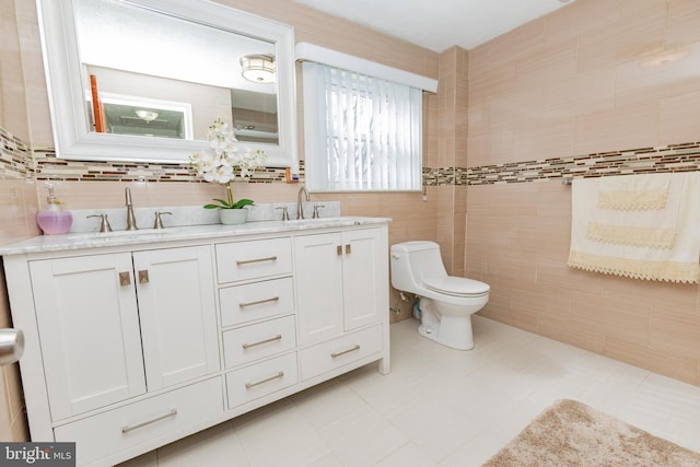 full bath featuring double vanity, toilet, tile walls, and a sink