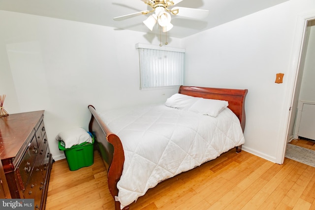 bedroom with baseboards, ceiling fan, and wood finished floors