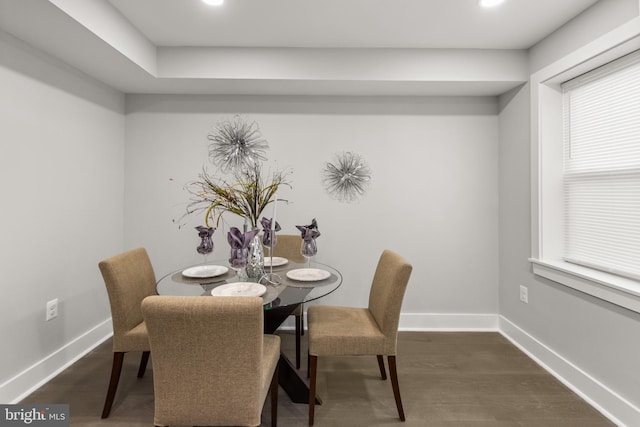 dining area with dark wood-style floors and baseboards