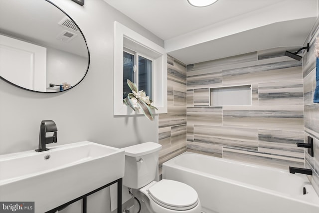 full bathroom with toilet, visible vents, shower / washtub combination, and a sink