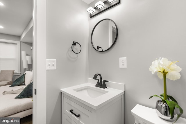 ensuite bathroom featuring vanity, toilet, and ensuite bathroom