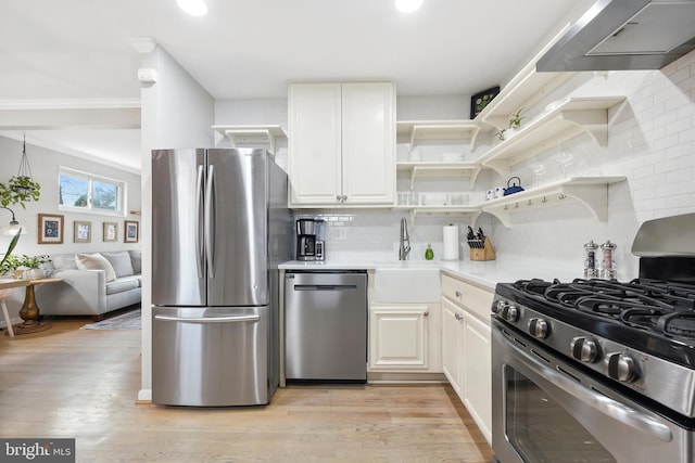 kitchen featuring stainless steel appliances, light countertops, white cabinetry, a sink, and exhaust hood