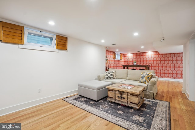 living room with wood finished floors, baseboards, and wallpapered walls