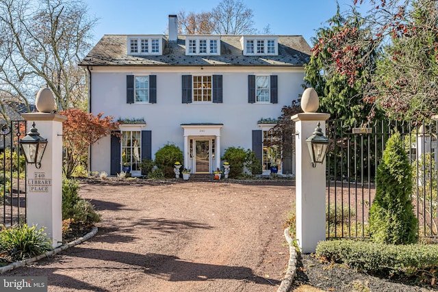 view of front of home with fence and a high end roof