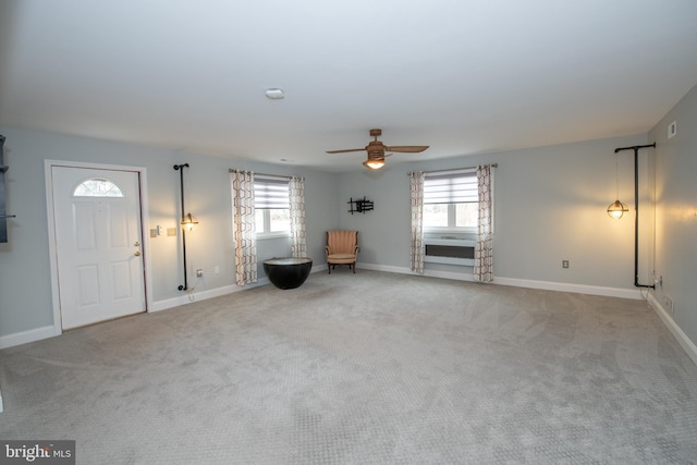 unfurnished room featuring a wealth of natural light, baseboards, and carpet