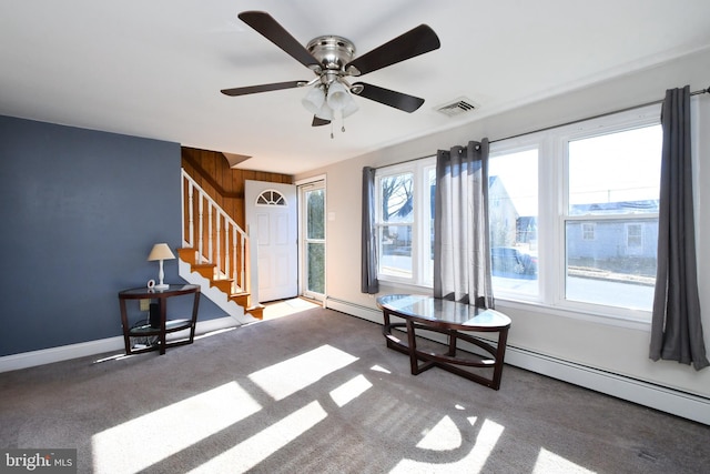 living area featuring a baseboard heating unit and carpet flooring