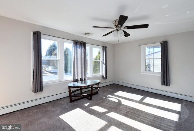 carpeted empty room with a baseboard radiator and plenty of natural light