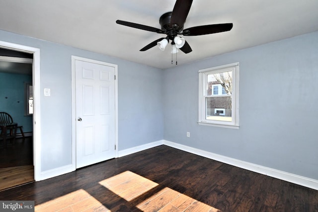 unfurnished bedroom with ceiling fan and dark hardwood / wood-style flooring