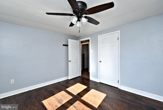 unfurnished bedroom with dark wood-type flooring and ceiling fan