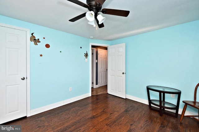 interior space featuring ceiling fan and dark wood-type flooring