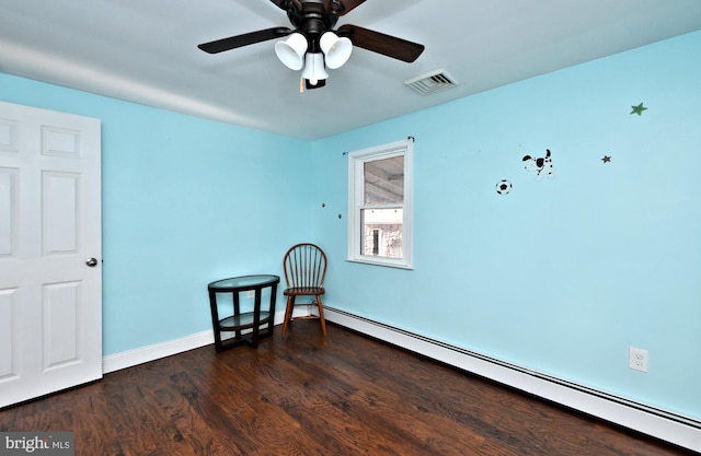 living area featuring dark hardwood / wood-style flooring, ceiling fan, and a baseboard heating unit