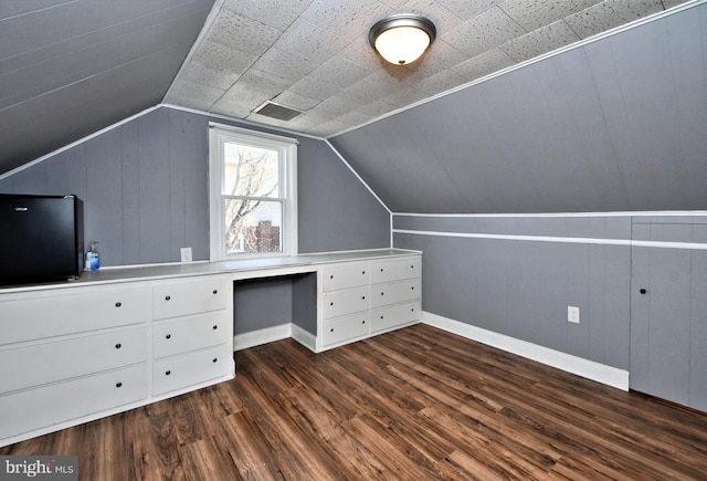 bonus room featuring lofted ceiling and dark wood-type flooring