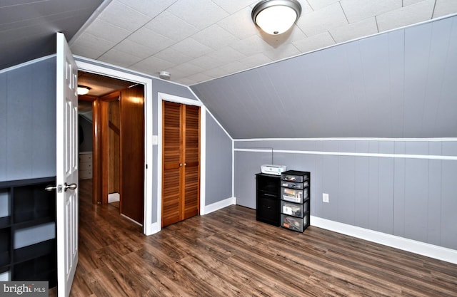 bonus room with lofted ceiling and dark hardwood / wood-style floors