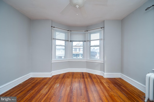 unfurnished room with hardwood / wood-style flooring and ceiling fan