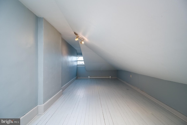 bonus room featuring a baseboard radiator, vaulted ceiling, and light hardwood / wood-style floors