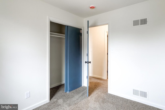 unfurnished bedroom with light carpet, baseboards, visible vents, and a closet