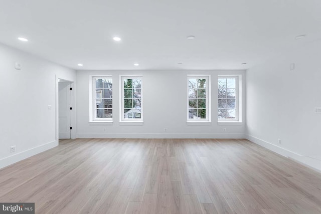 unfurnished living room with light hardwood / wood-style floors and plenty of natural light