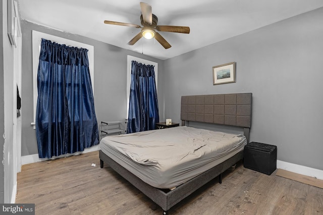 bedroom with ceiling fan and light hardwood / wood-style floors