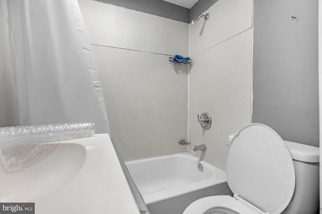 bathroom with shower / tub combo and toilet