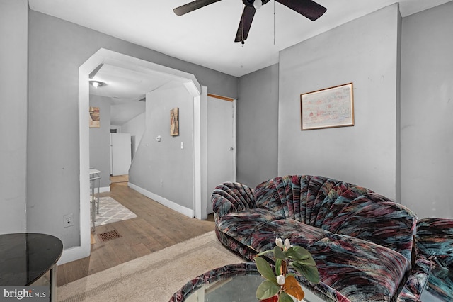 living room with light hardwood / wood-style flooring and ceiling fan