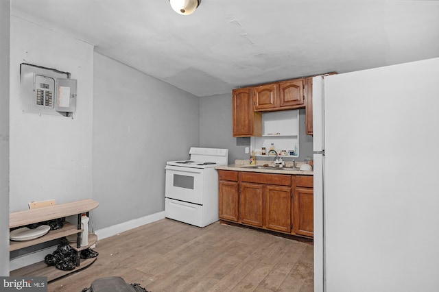 kitchen with white appliances, light hardwood / wood-style flooring, and sink