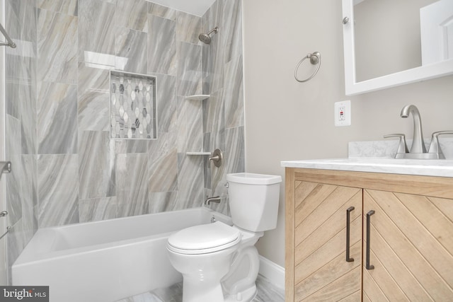 full bathroom featuring tiled shower / bath combo, vanity, and toilet