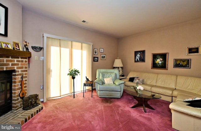 living room featuring carpet and a brick fireplace