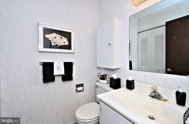 bathroom featuring vanity and toilet