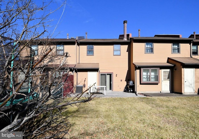 back of house with a yard, a patio, and central AC