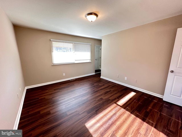 unfurnished bedroom featuring dark hardwood / wood-style floors