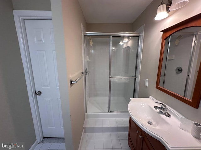 bathroom featuring vanity, tile patterned flooring, and walk in shower