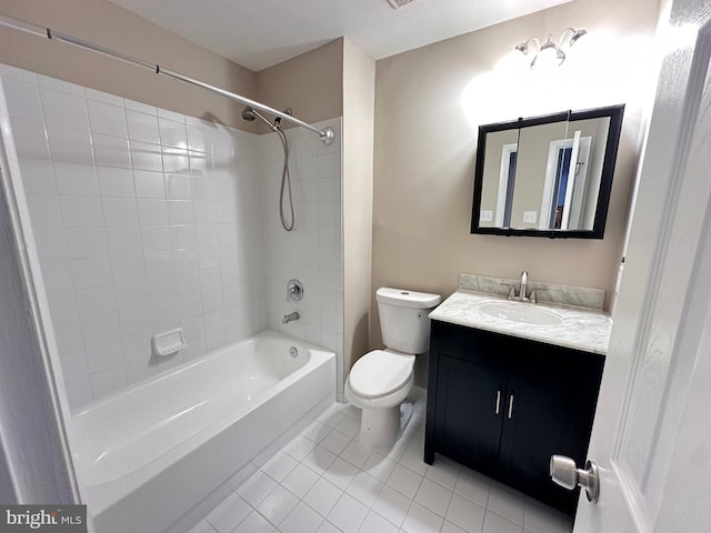 full bathroom with tile patterned flooring, vanity, tiled shower / bath, and toilet