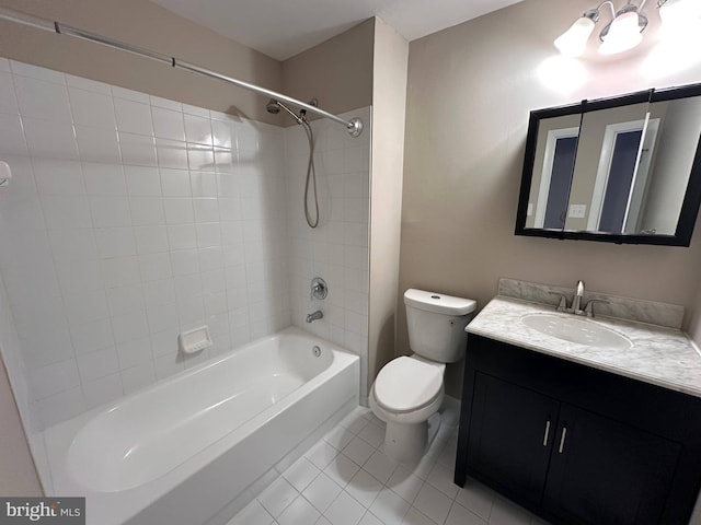 full bathroom featuring toilet, tile patterned flooring, vanity, and tiled shower / bath