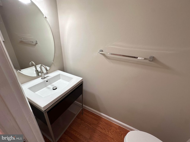 bathroom featuring vanity, toilet, and hardwood / wood-style floors