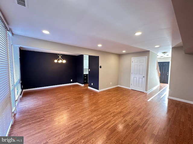 interior space featuring an inviting chandelier and wood-type flooring