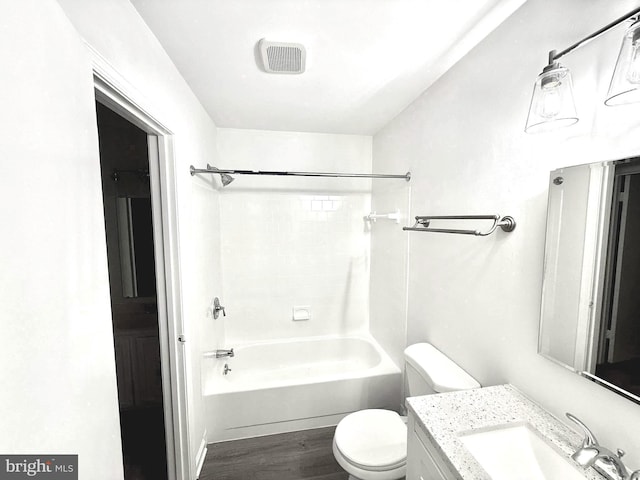 full bath with visible vents, toilet, shower / bathtub combination, wood finished floors, and vanity