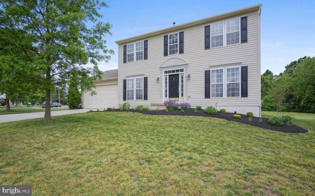 colonial home with concrete driveway, a front lawn, and an attached garage